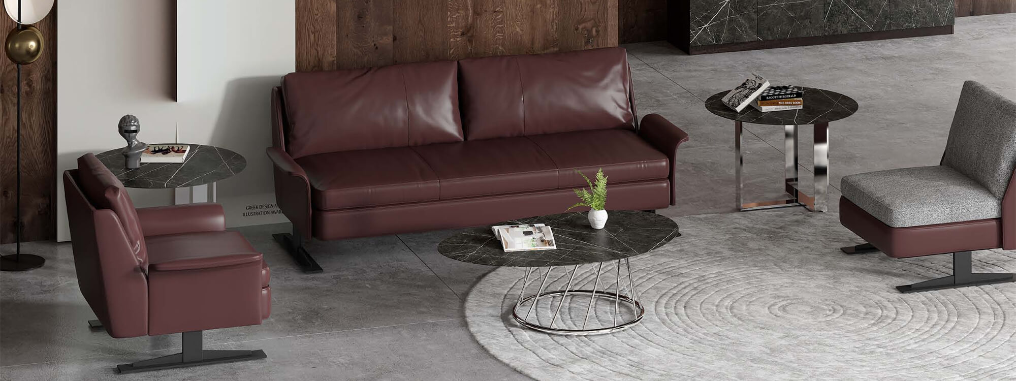 Double and single sofas in brown leather and two sintered stone coffee tables and a fabric sofa chair.