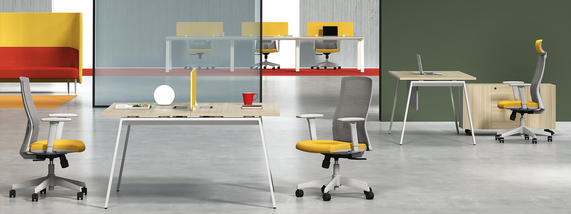 In the office is a two-seater workstation next to an office chair with a yellow cushion.